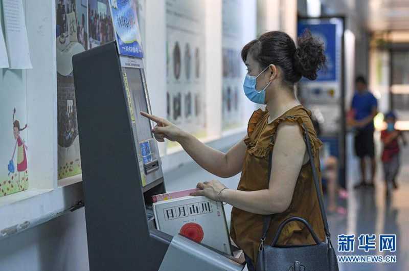 6月21日，市民在海南省图书馆利用自助设备借阅书籍。 新华社记者 蒲晓旭 摄
