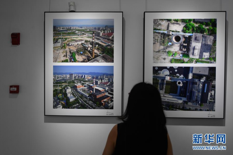 6月12日，观众在奉化博物馆观看“对话热电厂·博物馆” 摄影展。摄影师通过不同角度记录了热电厂改建前后的变化。 当日，主体建筑由原热电厂发电车间改造而来的浙江省宁波市奉化博物馆首次向公众开放。该博物馆建筑保留了原热电厂的柱梁等钢结构体系和煤斗、耐火砖等工业遗存，带有浓厚的工业风。展厅面积约6000平方米，由3个常设展厅和5个临时展厅组成，目前基本陈设的文物达3000多件。 新华社记者 黄宗治 摄