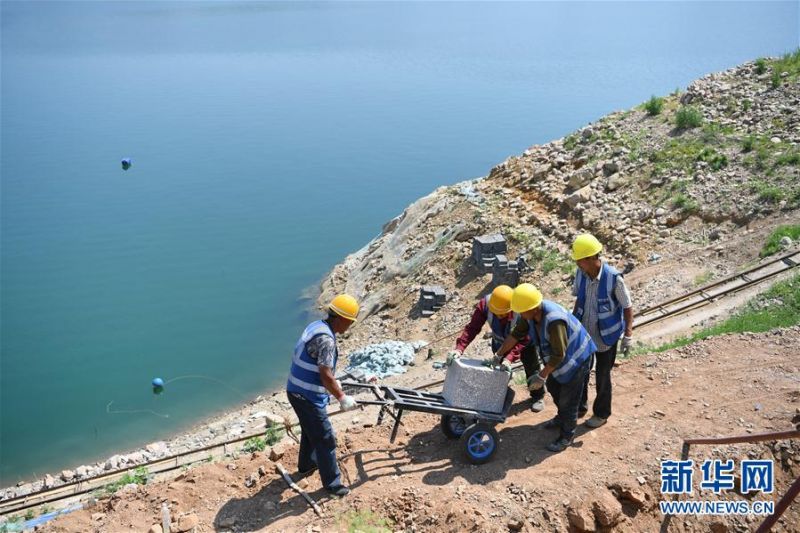 　6月19日，工人在喜峰口西潘家口段长城保护维修工程现场搬运修缮长城墙体所用石料。 新华社记者 牟宇 摄