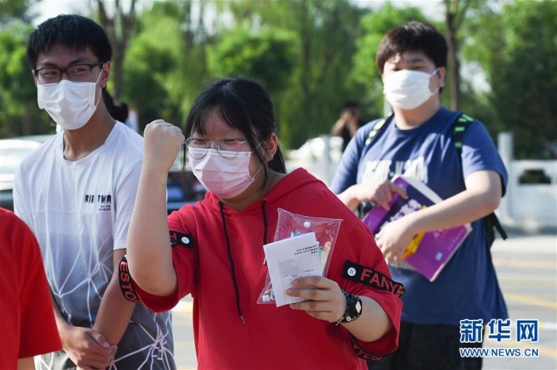 张晶（中）在排队进入考场时给自己加油（7月7日摄）。新华社记者 鞠焕宗 摄