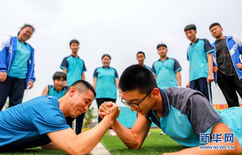 　6月22日，河北省邯郸市邯山区第一中学的高三学生和老师进行“掰手腕”游戏。 2020年高考临近，河北省邯郸市邯山区第一中学在积极做好高三学生复习备考的同时，开展多种形式的减压活动，帮助学生释放紧张情绪。 新华社记者 王晓 摄