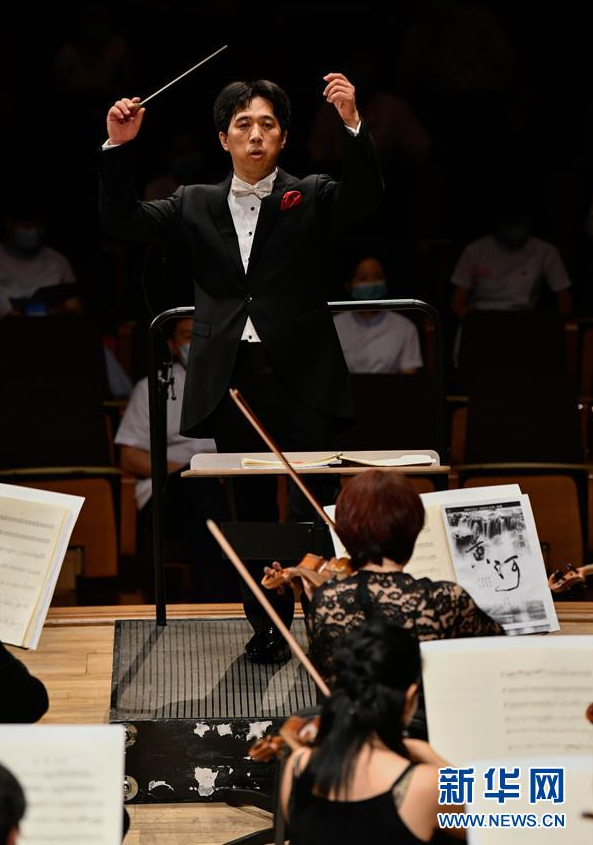 8月1日，在天津大剧院音乐厅，指挥家董俊杰在指挥乐团演出。 当日，“民生之夜——《我爱你中国》大型交响音乐会”在天津大剧院音乐厅举行，拉开了复工复产后天津市音乐类剧场演出的帷幕。 新华社发（孙凡越 摄）