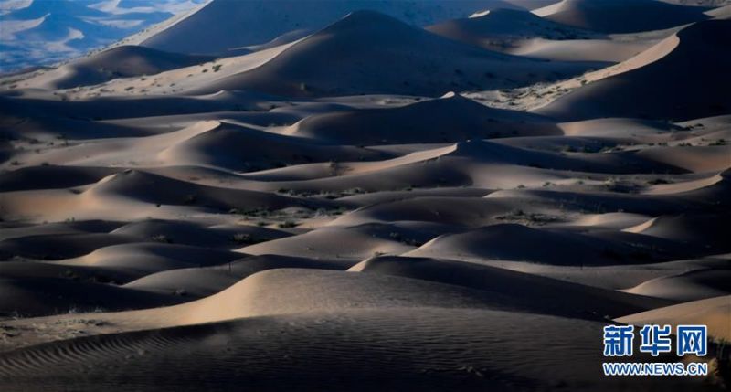 　　这是7月8日拍摄的腾格里沙漠风光。 位于内蒙古自治区阿拉善左旗西南部和甘肃省中部边境的腾格里沙漠是我国第四大沙漠，总面积约为4.3万平方公里。夏日傍晚，腾格里沙漠连绵的沙丘被日光勾勒出美丽的线条，美不胜收。 新华社记者 连振 摄