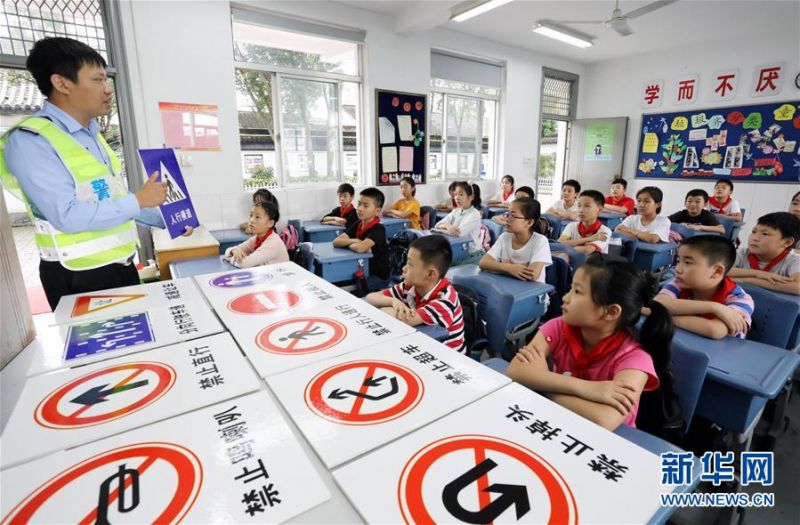7月10日，在江苏省苏州市大儒中心小学校，一名交警为学生讲解交通安全知识。 近日，各地学校开展“暑假安全课”主题活动，加强学生们的安全意识。 新华社发（杭兴微 摄）