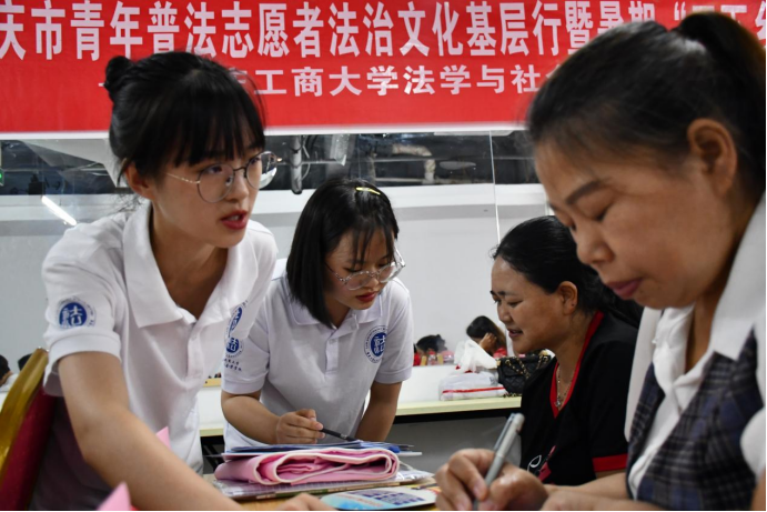 图为青年普法志愿者服务队针对基层群众开展普法宣讲与法治调研。通讯员 周金马摄
