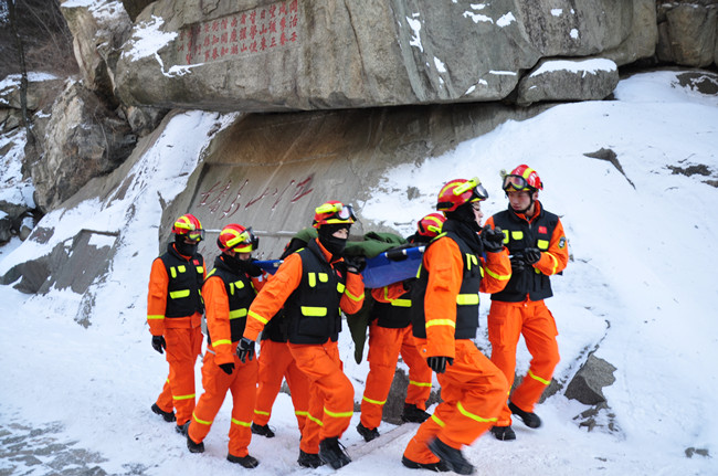 雪中救援，大家轮流抬着担架。 泰山消防救援站供图