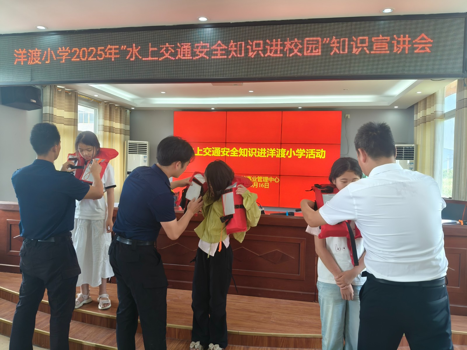 为学生示范指导救生衣的正确穿法。拍摄：张耀升.jpg