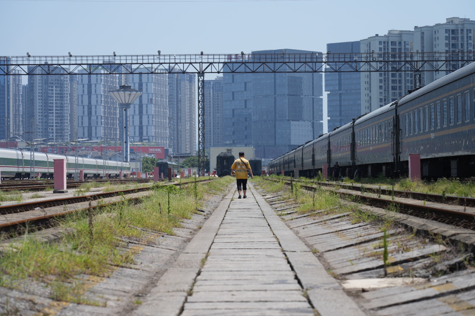 在重庆北站客车整备所内，连结员顶着烈日前往作业点位（魏伟 摄）.jpeg
