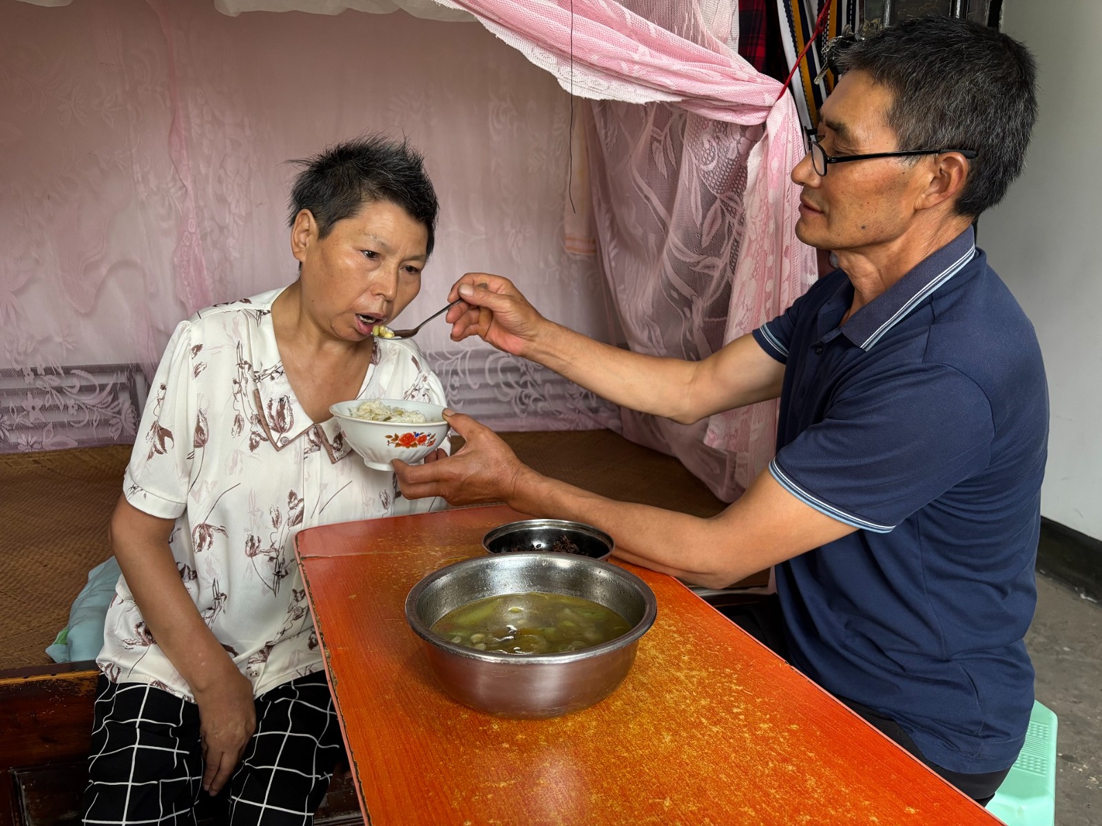 胡继寿照顾妻子生活起居。图源：拔山镇1.jpg