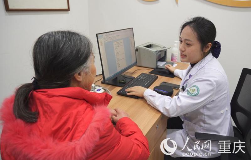 渝中区上清寺街道社区卫生服务中心，谢仁玉了解莫婆婆的健康情况。人民网记者 刘祎摄