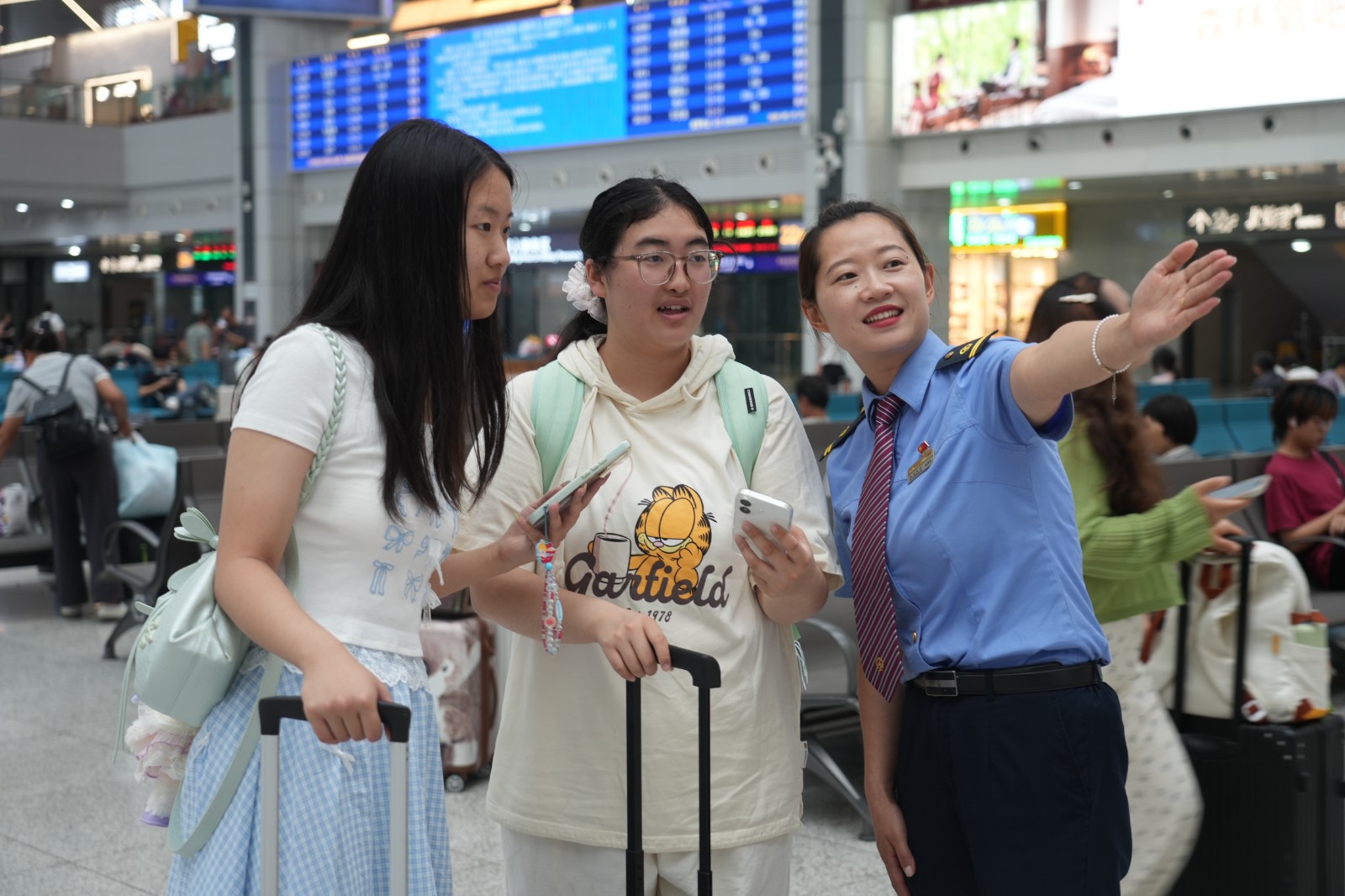 重庆北站工作人员为学生旅客解答问题。汪亮 摄.jpg
